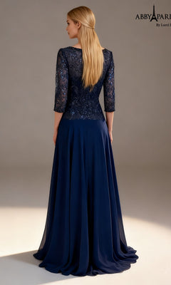 A woman stands facing away, wearing the Abby Paris 96099 long formal dress in navy blue. The lace bodice features three-quarter sleeves and is adorned with sequin-embellished detailing for a touch of sparkle, while the long, flowing chiffon A-line skirt completes the elegant look. Her straight blonde hair falls loosely down her back.