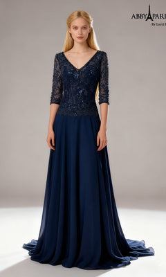 A woman wearing the Abby Paris 96099 long formal dress in navy, featuring elegant lace sleeves, a sequin-embellished bodice, and a graceful chiffon A-line skirt, stands against a plain background.