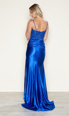 A woman with blonde hair faces away, wearing the Beaded-Bodice Long Prom Dress (Poly USA 9616)—a royal blue satin evening gown featuring thin straps and a beautifully embellished bodice.