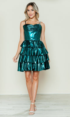 A woman poses against a plain backdrop in the Poly USA 9678 Metallic Short Ruffled Hoco Dress, a sleeveless shiny teal dress paired with beige high-heeled sandals.