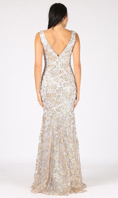 A woman wearing the Sequin-Print Long Prom Dress: Eureka 9706, a floor-length sleeveless gown with gold floral sequins and a deep V-back, stands against a plain white background.