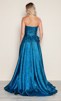A woman with long blonde hair is shown from the back wearing the Poly USA 9720 Side-Bow Strapless Prom Gown, featuring a floor-length glitter skirt, against a plain light-colored wall.