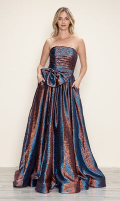A woman models the Poly USA 9720 Side-Bow Strapless Prom Gown in metallic blue and copper, featuring a large waist bow, against a simple light background.