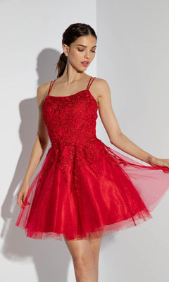 A woman models the Eureka 9727 Lace-Up Short Prom Dress, a sleeveless floral lace cocktail dress with intricate detailing and an A-line skirt, standing gracefully against a white background.