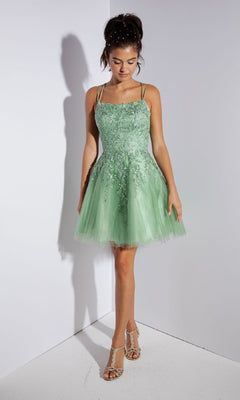 A young woman stands wearing the Eureka 9727 Lace-Up Short Prom Dress, featuring a light green a-line silhouette with floral embroidery, a tulle skirt, and strappy sandals.