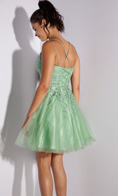 Woman wearing the Eureka 9727 Lace-Up Short Prom Dress in light green, a sleeveless tulle design with floral embroidery and crisscross back straps, stands looking down.