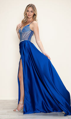 A woman poses on a wooden floor against a light background, wearing the Poly USA 9746 Beaded-Corset Long Prom Dress in Royal—a blue evening gown with a thigh-high slit and sheer, beaded corset bodice.
