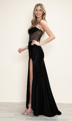 A woman poses sideways against a light background, wearing the Sheer Beaded-Corset Long Prom Dress: Poly USA 9750—featuring a black beaded sheer bodice, thigh-high slit, and paired with silver high-heeled sandals.