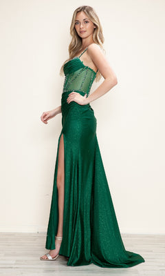 A woman stands sideways against a plain light wall, wearing the Sheer Beaded-Corset Long Prom Dress (Poly USA 9750)—a green, floor-length gown with a beaded sheer bodice and thigh-high slit.