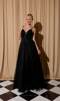 A woman wearing the Lace-Up Long Shimmer Prom Dress: Eureka 9797 stands on a black-and-white checkered floor in front of beige curtains.