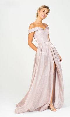 A woman stands smiling against a plain background, wearing the Eureka 9808 Off-Shoulder Long Glitter Prom Dress in light pink, featuring a floor-length design and thigh-high slit.
