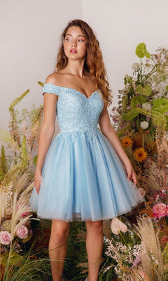 A young woman wears the Eureka 9833 Off-the-Shoulder Short Hoco Dress, standing among lush green plants and vibrant flowers.