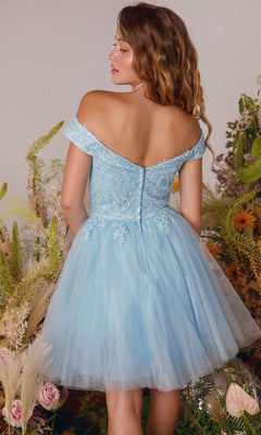A woman stands with her back to the camera among flowers and greenery, wearing the Eureka 9833 Off-the-Shoulder Short Hoco Dress in light blue with lace and tulle.