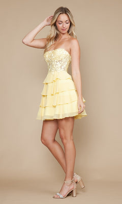 Model wears the Strapless Short Ruffled Hoco Dress: Poly USA 9838, showcasing a yellow sequined corset bodice and tiered ruffle skirt, styled with nude high-heeled sandals against a beige background.