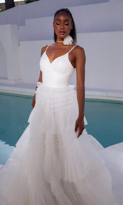 A woman in the Eureka 9888 Lace-Up Long Glitter-Tulle Prom Dress poses by a pool, set against a plain white background.