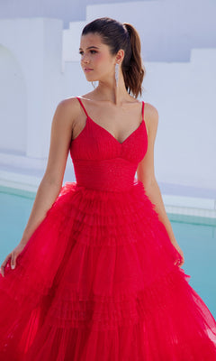 Woman in a Lace-Up Long Glitter-Tulle Prom Dress (Eureka 9888) with ruffled details stands by a pool, looking to the side. She wears her hair in a ponytail and accessorizes with long, dangling earrings.