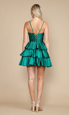 A woman with long blonde hair models the Poly USA 9894 Ruffle Short Corset Hoco Dress in green, featuring a lace-up back, paired with nude heels against a plain beige background.