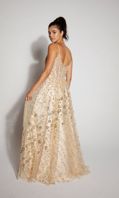 A woman wears the Long Glitter A-Line Prom Dress: Eureka 9908, featuring gold embroidery and a sleeveless, floor-length design, as she poses against a plain white background looking over her shoulder.