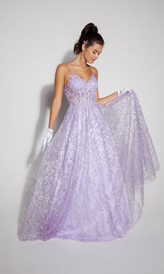 A woman wearing the Long Glitter A-Line Prom Dress: Eureka 9908, featuring lilac floral embroidery, stands against a plain background, holding out part of her dress while accessorizing with white gloves and a matching hairpiece.