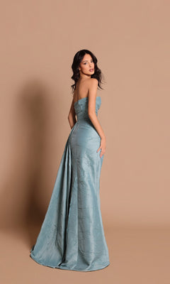 Model wears the Long Formal Dress: Tarik Ediz 99105, a strapless light blue gown with a high slit, posing against a plain beige background and glancing over her shoulder at the camera.