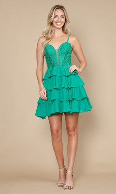 A woman wears the Poly USA 9918 Ruffled Short Corset Hoco Dress—a green fit-and-flare A-line with ruffled skirt, fitted bodice, lace-up back, and thin straps—paired with strappy heels against a beige background.