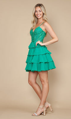A woman stands sideways against a beige background wearing the Poly USA 9918 Ruffled Short Corset Hoco Dress in green with lace detailing, a lace-up back, and nude high-heeled sandals.