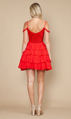 A woman faces away, modeling the Poly USA 9920 short homecoming dress—a bright red, off-the-shoulder fit-and-flare style with a ruffled chiffon a-line skirt—paired with strappy heels against a plain beige background.