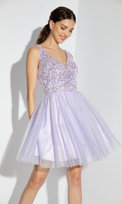 A woman in the Eureka 9926 Glitter-Bodice Short A-Line Hoco Dress, featuring a sleeveless sequin bodice and flared light purple tulle skirt, stands against a white background.