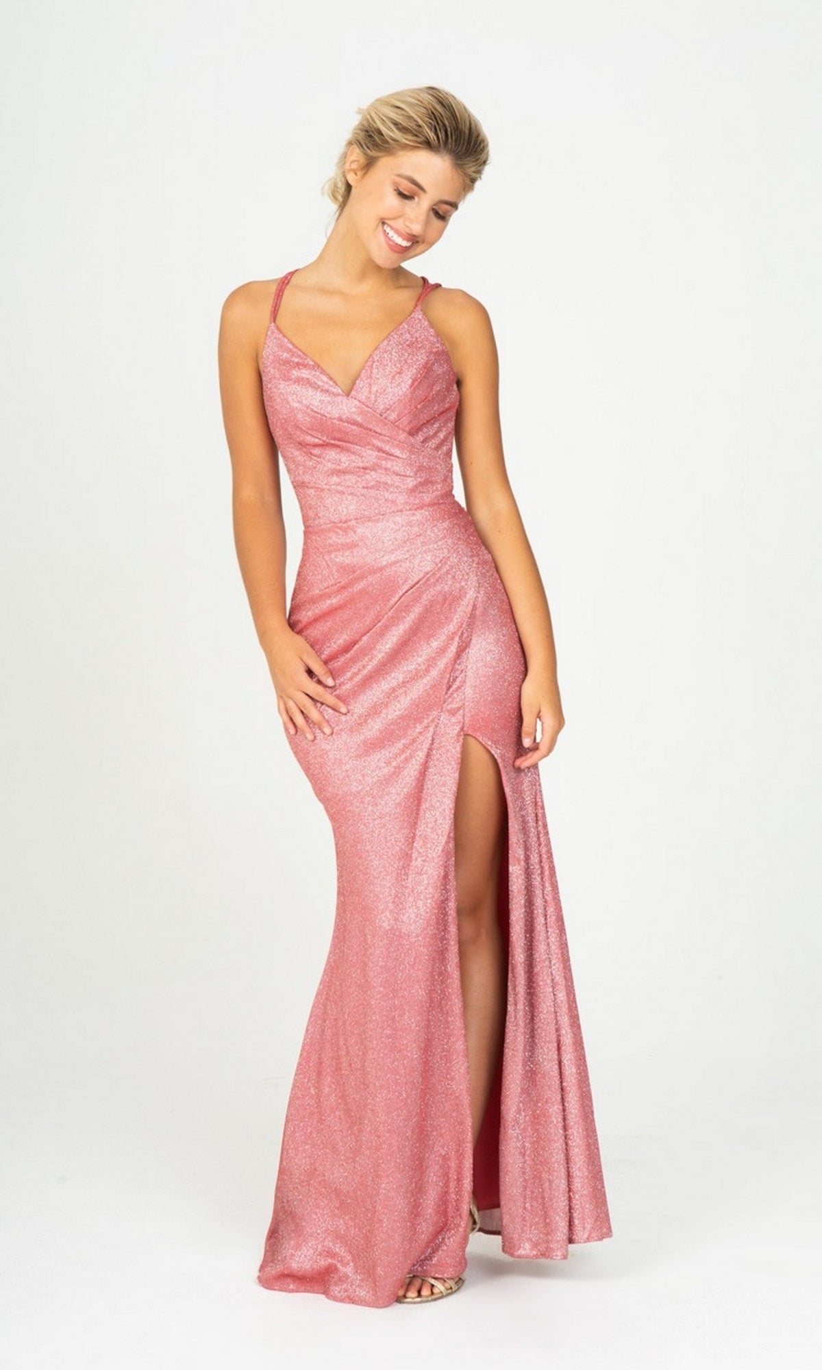 Woman wearing Long Prom Dress: Eureka 9933 in ruby red glitter jersey with a thigh-high slit, standing and smiling against a plain white background.