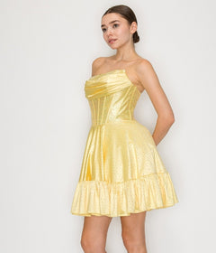 A woman models the Short Homecoming Dress: Poly USA 9942, featuring a strapless yellow fitted bodice and a ruffled hem, standing against a plain white background.