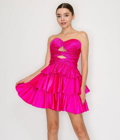 A woman models the Poly USA 9944 short homecoming dress in hot pink, showcasing its strapless heart-shaped bust, front cutout, and tiered fit-and-flare mini skirt against a simple light background.