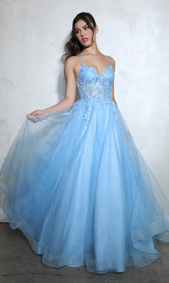 A woman stands against a plain light wall wearing the Lace-Up Corset Long Prom Ball Gown: Eureka 9960, a light blue, floor-length A-line dress featuring a sheer bodice, floral appliques, and thin straps.