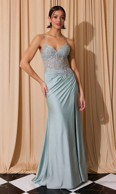 A woman poses before beige curtains wearing the Floral-Bodice Long Glitter Prom Dress: Eureka 9969, a light blue floor-length gown featuring thin straps, a sheer lace bodice, and subtle glitter accents.