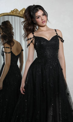 A woman in the Eureka 9980 Long Glitter-Tuller A-Line Prom Dress stands before a mirror, her reflection visible against a plain, light-colored background.
