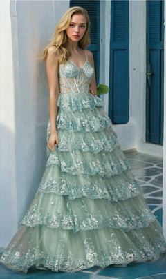 A woman in the Juliet JT2454K Long Ruffled A-Line Prom Ball Gown, light green with silver sequin details, poses on a tiled floor against a white wall with blue shutters.