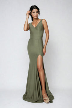 Woman wearing the Atria Open-Back Sleeveless Long Prom Dress 6024H in olive green, featuring a V-neckline, open-back detail, and high slit, standing against a plain light background.