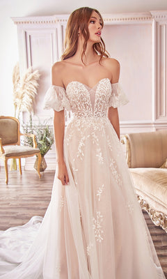 A woman wearing the Puff-Sleeve Long White Wedding Dress A1014, featuring lace embroidery and removable puff sleeves, stands in an elegant room with classic décor and neutral furniture.