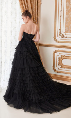 A woman in the Strapless Tiered Long Prom Ball Gown A1017 stands with her back to the camera in an ornate room featuring gold accents and patterned curtains.