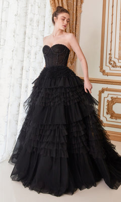 A woman in the Strapless Tiered Long Prom Ball Gown A1017, featuring a fitted bodice and layered skirt, stands in an ornate room with gold-trimmed walls and white curtains.