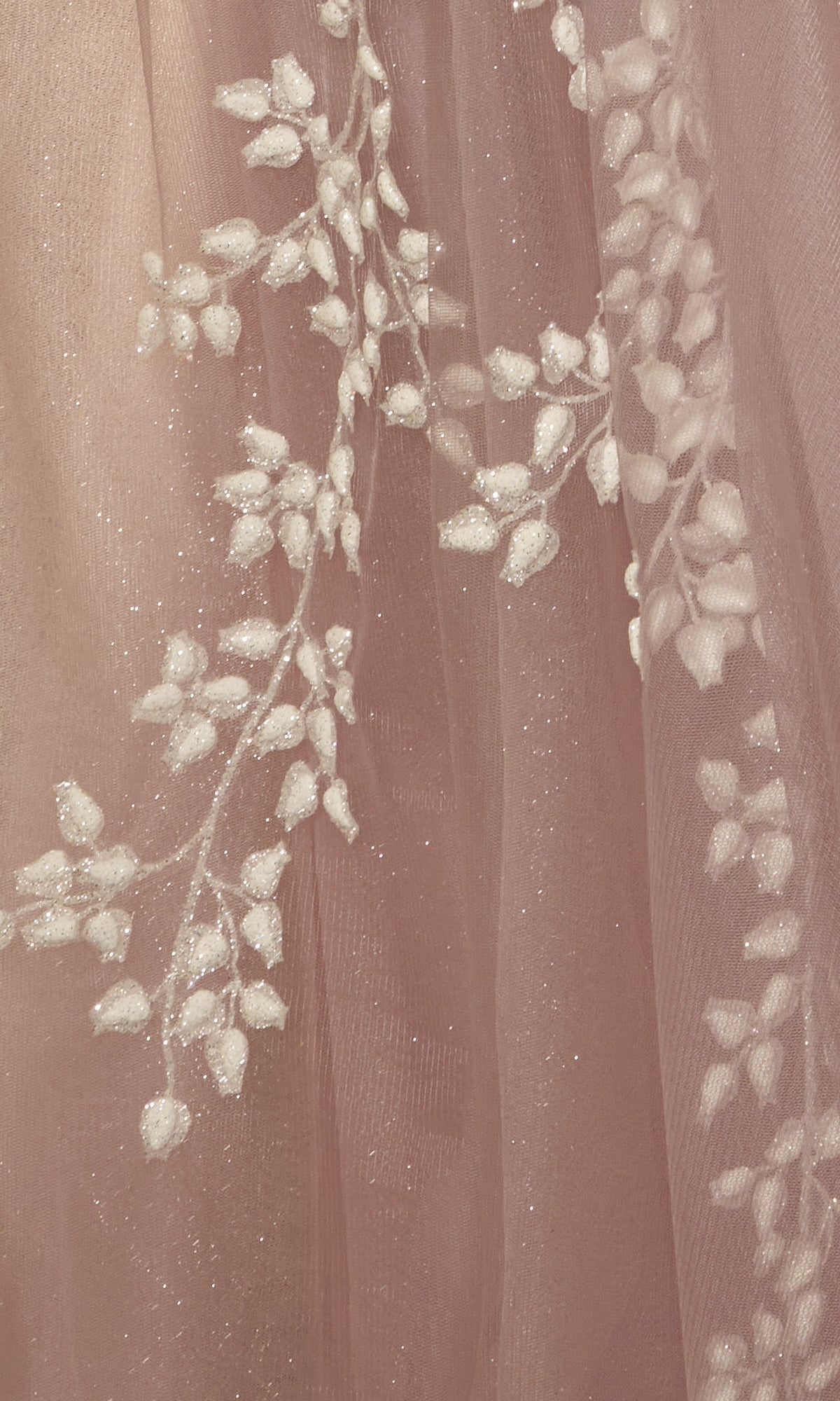 Close-up of sheer pink fabric with glittery white floral embroidery, perfect for the Strapless Sweetheart Prom Ball Gown A1029, ideal for formal evenings or prom.