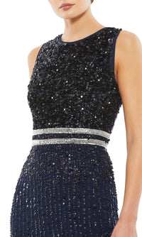 A woman wears the Mac Duggal 10509 Short Sequin Wedding Guest Dress, a sleeveless dark blue dress featuring silver beaded detailing at the waist, shown from shoulders to hips.