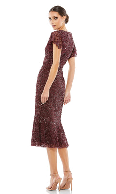 Woman wearing the Short Wedding Guest Dress 10801 by Mac Duggal—a burgundy, sequin-embellished knee-length dress with flutter sleeves—stands in heels and looks over her shoulder against a white background.