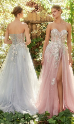 Two women wear Strapless Sweetheart Floral Prom Ball Gown A1089: one in sheer pastel light blue, the other in light pink with an a-line silhouette, thigh-high slit, and floral appliqués, standing amid lush greenery.