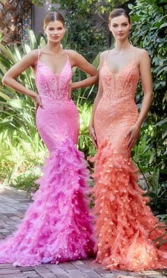 Two women stand outdoors amid green plants, each wearing the Long Mermaid Formal Gown with Feathers A1116—one in pink and the other in peach—featuring fitted silhouettes and feathered skirts.