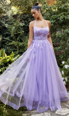 A woman stands in a garden wearing the Butterfly Sheer-Bodice Prom Ball Gown A1141, featuring lavender tulle with floral embroidery and delicate appliqué details.