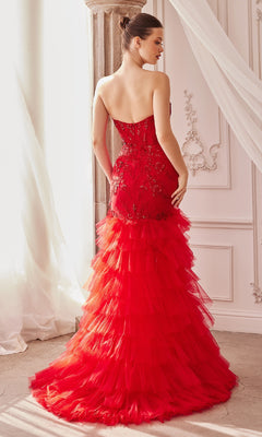 A woman stands indoors, facing away, wearing the Strapless Fitted Ruffle Prom Dress A1255 featuring a mermaid silhouette with lace details and a dramatic ruffle tulle skirt.