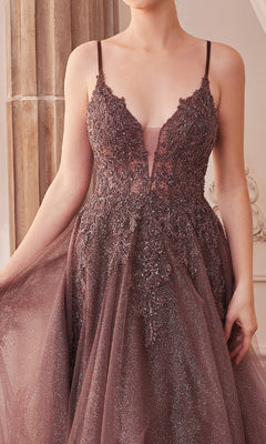 A woman wears the Sage Green Long Glitter-Tulle Prom Dress A1261, featuring a sleeveless, deep V-neck design with sequin details, and holds one side of the gown.