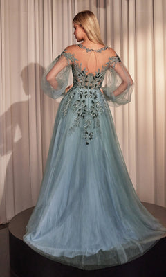 A woman in the Sheer Long Sleeve Long Formal Dress A1263, featuring a light blue hue and intricate floral embroidery, stands on a round platform facing away from the camera before pale curtains.