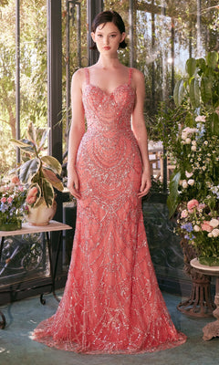 A woman stands indoors in the Andrea & Leo A1363 Beaded Long Prom Dress, a fitted floor-length mermaid gown, surrounded by potted plants and flowers near a glass door.