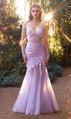 A woman stands outdoors in the Andrea & Leo A1388 Strapless Mermaid Prom Dress, featuring sequins and a sheer tulle skirt, with sunlight filtering through the trees behind her.